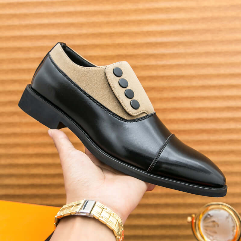 Giotto dual tone men's dress shoes held in hand, showing black leather and suede contrast with cap toe design.