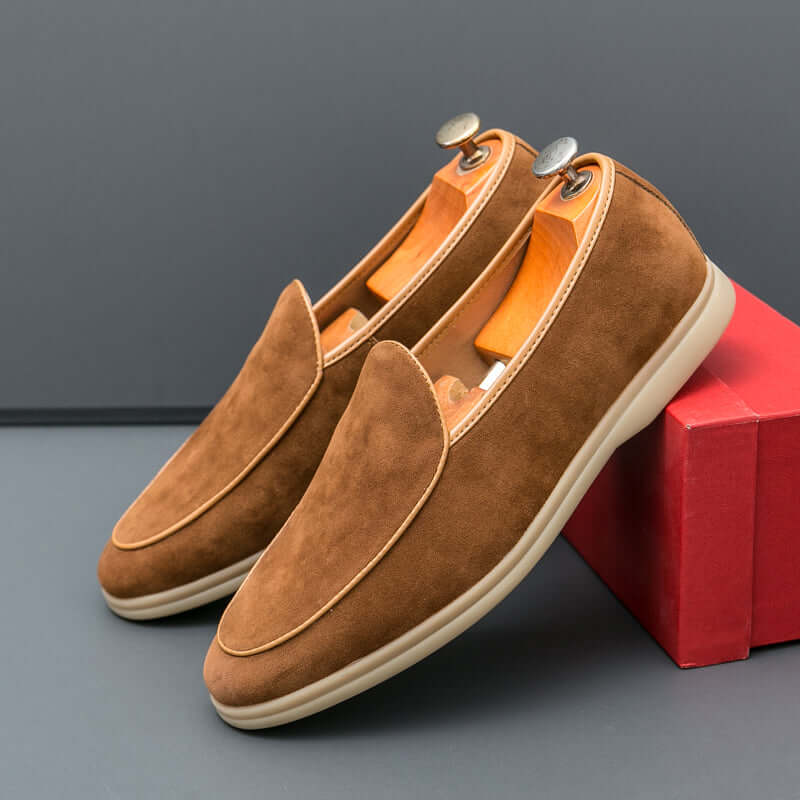 Vallare Leather Loafers in brown, featuring a sleek minimalist design, slip-on comfort, genuine leather construction, and lightweight sole.