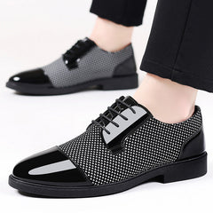 Stylish men's formal dress shoes in black and white pattern with glossy finish, perfect for upscale occasions.