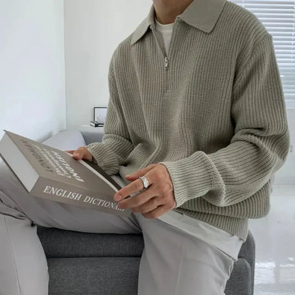 Man wearing Briar Quarter Zip Sweater, crafted from soft jacquard knit, showcasing relaxed fit and timeless winter style in a neutral setting.