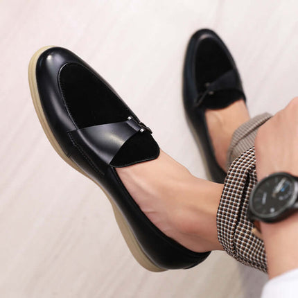 Matteo Leather Loafers in black showing suede details and hook accent, worn with checkered trousers for a formal, stylish look.
