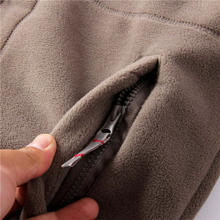 Close-up of grey men's hooded jacket pocket with zipper detail, showcasing double-layer lining for added warmth and style.