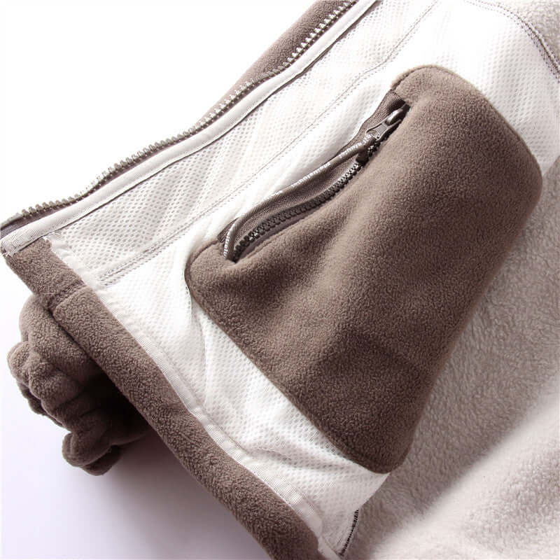 Close-up view of the sleeve and zipper pocket on a men's hooded jacket with double-layer lining.