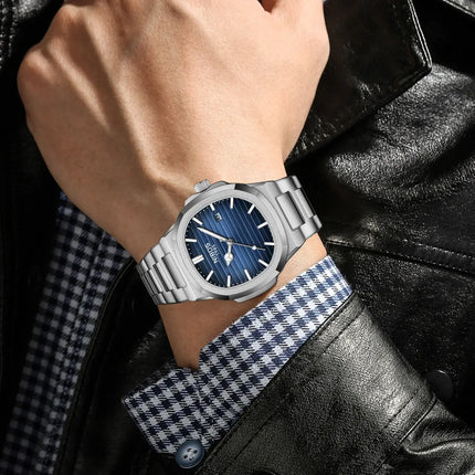 Man wearing Rivano Prestige 40 luxury quartz watch with blue dial, showcasing modern style and precision.