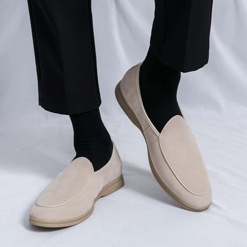 Man wearing Vallare Leather Loafers with black trousers, showcasing slip-on design and premium leather elegance for formal occasions.