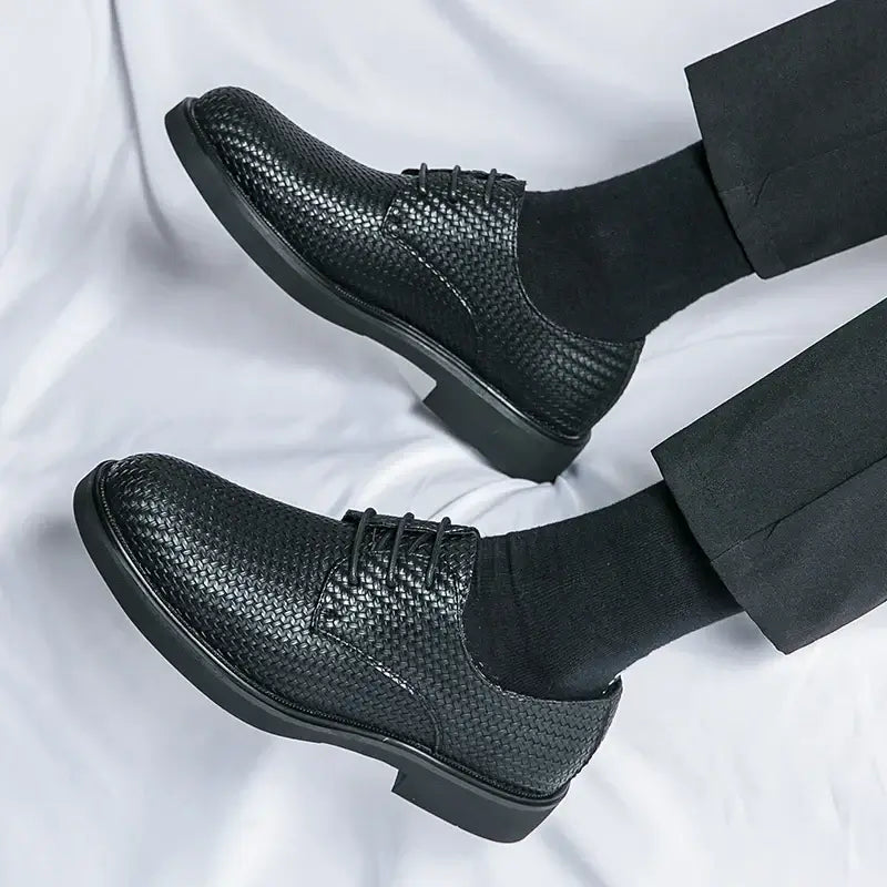 Black woven leather dress shoes with classic lace-up style and cushioned insole